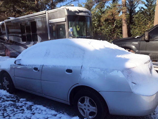 snow on the car and RV of the  two RV Gypsies